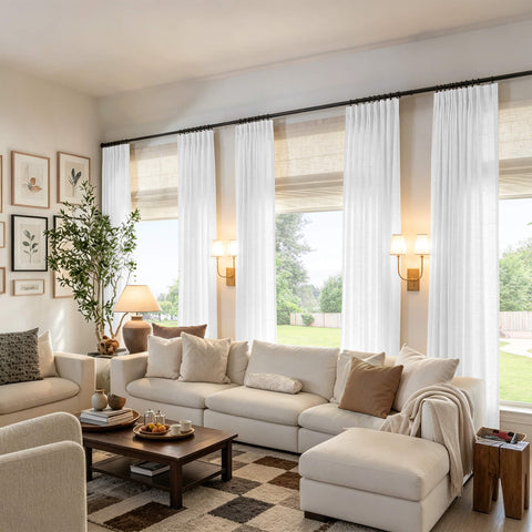 Light gray linen textured sheer curtains with vertical pinch pleats on a rod