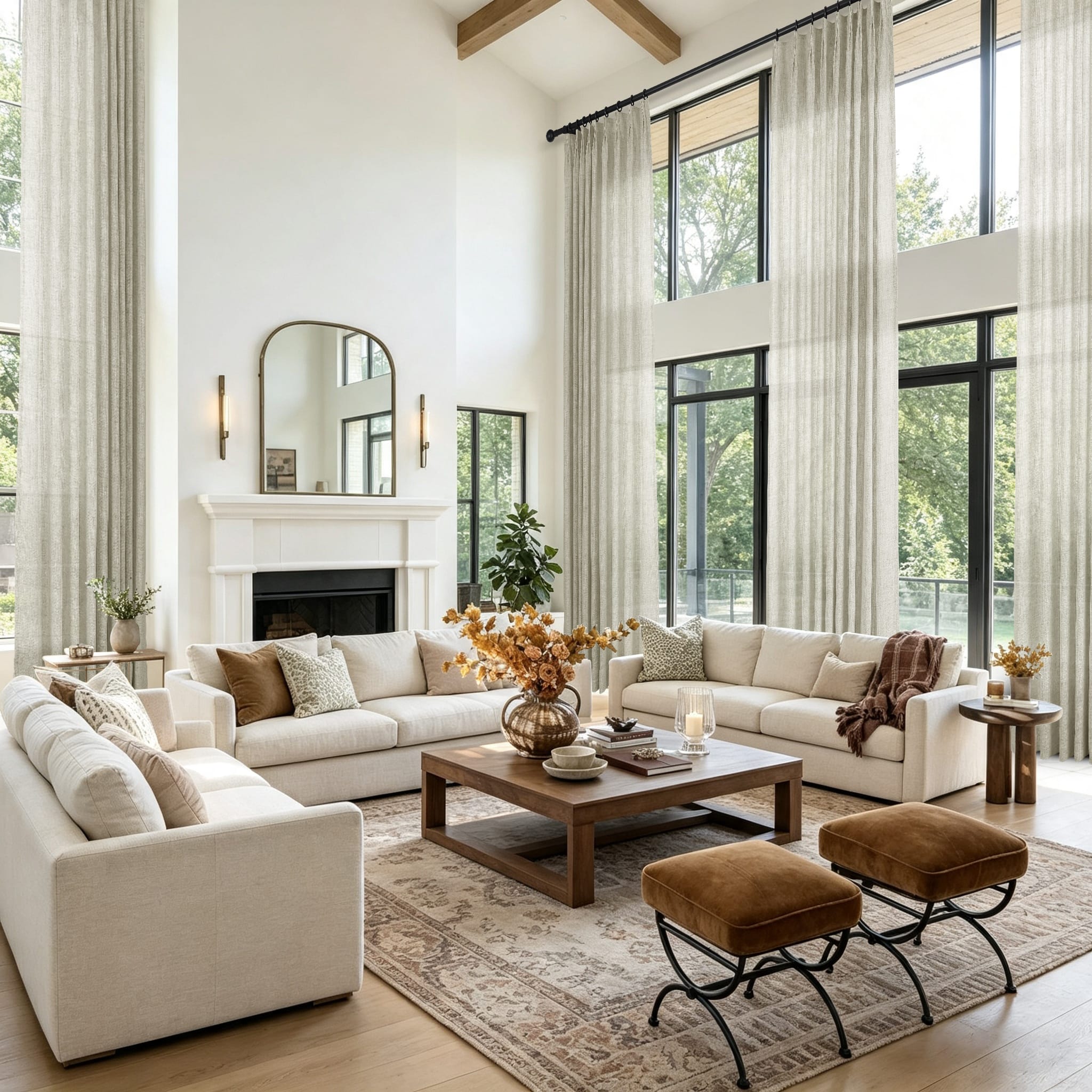 A bright modern living room featuring a large white sectional sofa and tall windows with light khaki sheer curtains