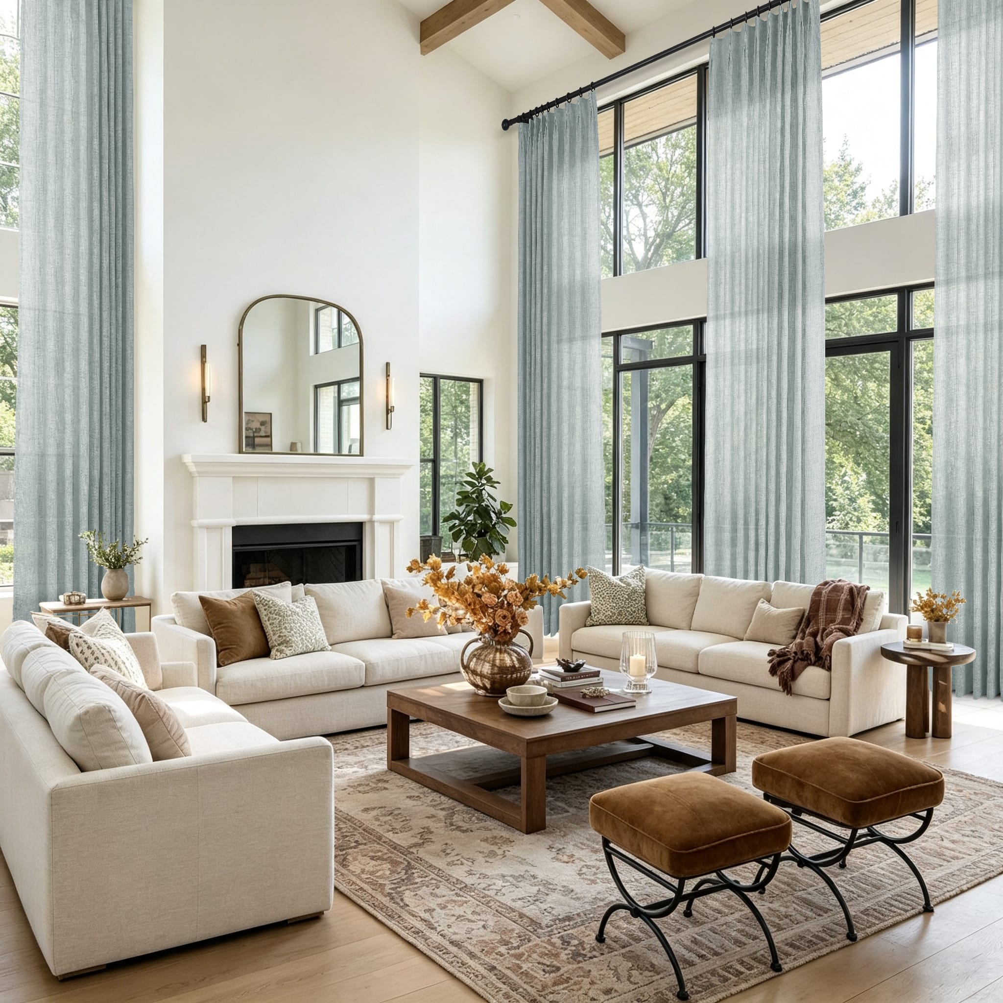 A bright modern living room featuring a cream sectional sofa and tall light blue gray curtains in front of large windows