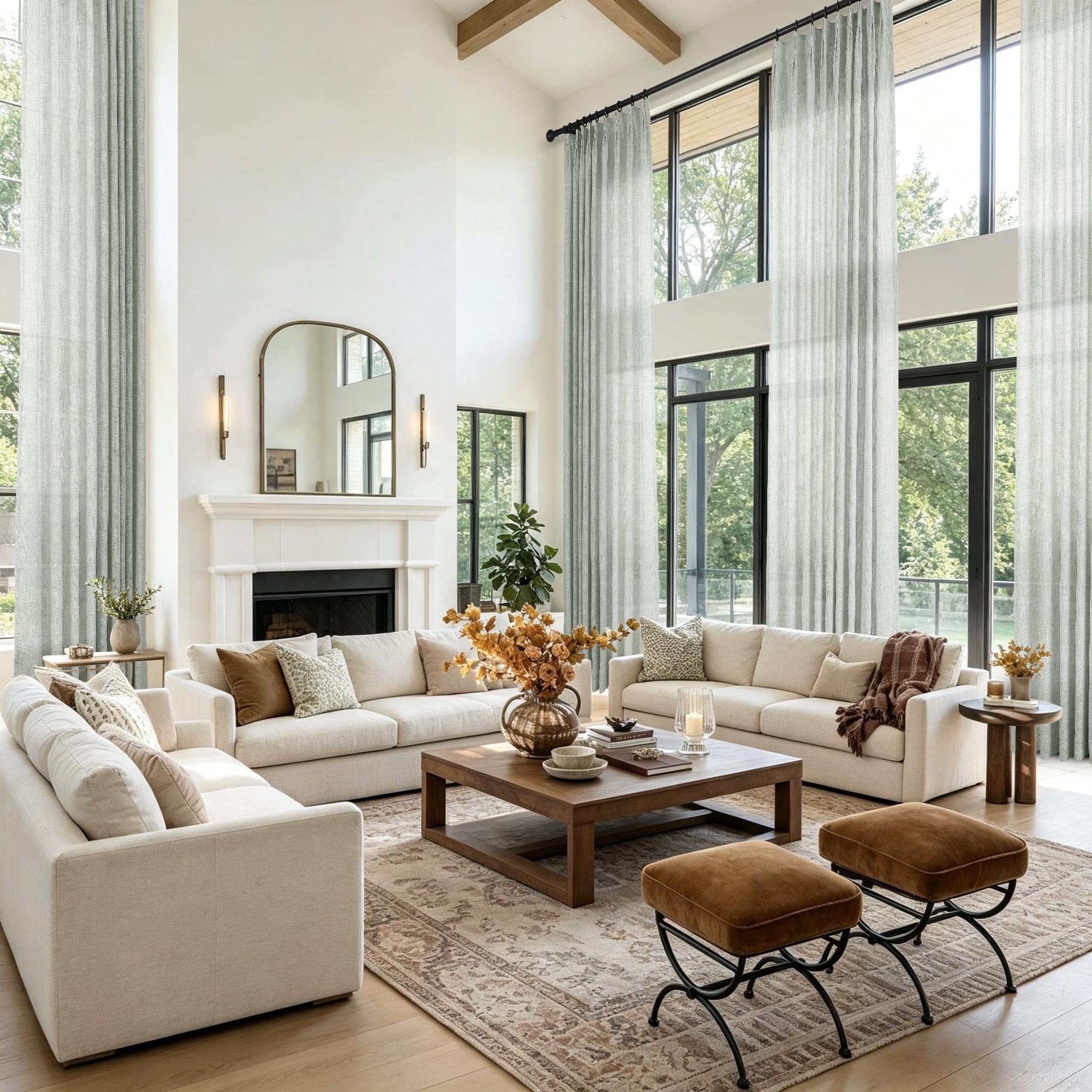 A bright modern living room featuring a large cream sectional sofa set against tall windows with sheer moss gray curtains
